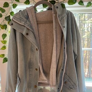 Jean jacket with sleeveless hoodie underneath.